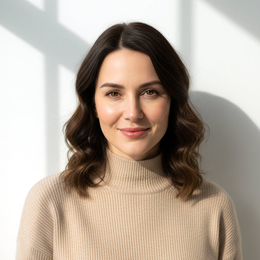 Brunette woman wearing a beige turtleneck sweater