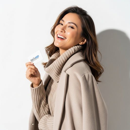 Photo of a smiling woman holding a SkinMD gift card